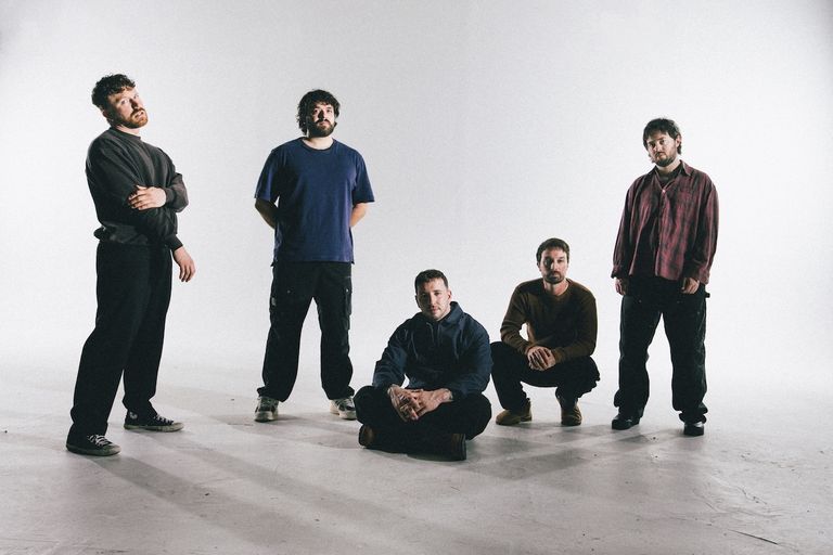 American rock band Citizen promotional photo by Atiba Jefferson showing five band members in casual clothes posing in a white studio space.